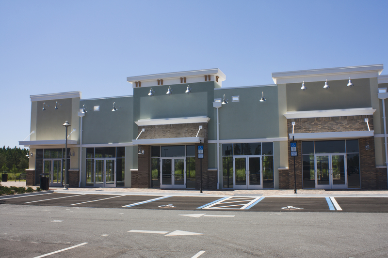 Pastel strip mall with stucco and traditional brick